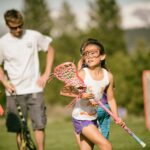 Girls Lacrosse player catching ball